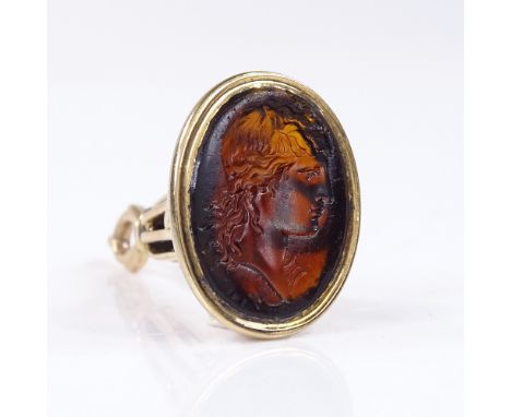 An unmarked gold intaglio glass seal fob, depicting Classical male portrait, signed, panel height 18.2mm, fob height 31mm, 5.