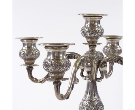 A German silver 4-branch candelabra, with relief embossed floral decoration and removable fittings, stamped 800, central stic