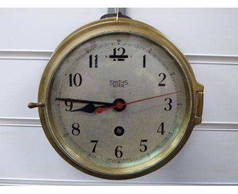 Smiths Astral ship's brass 8-day bulkhead clock, the silvered 135mm Arabic dial with black spade hands and contrasting red se