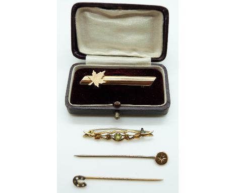 A Victorian stick pin set with a diamond, yellow metal brooches etc 