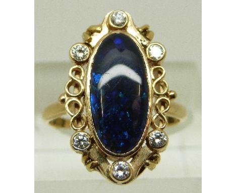 An 18ct gold Victorian ring set with an oval black opal cabochon and diamonds around the pierced surround, size P/Q, 5.8g 