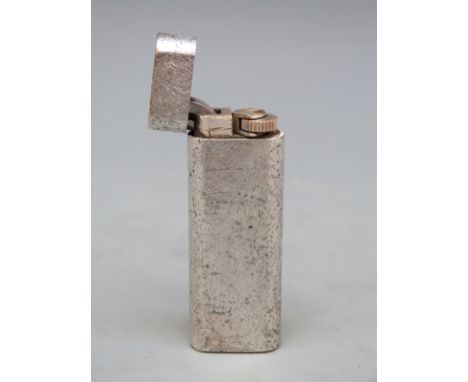 A brushed metal Cartier cigarette lighter 