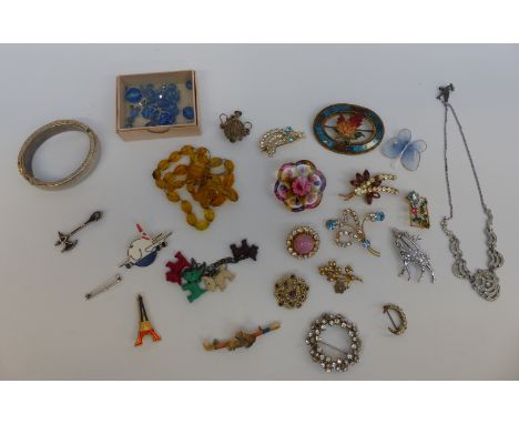 A collection of costume jewellery including white metal Victorian brooch in the form of an axe, paste brooches, Hollywood bro