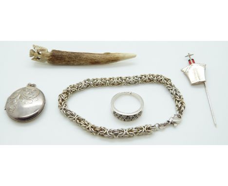 A silver locket, silver ring set with sapphires, a stick pin in the form of a ship, silver bracelet and a thistle brooch 