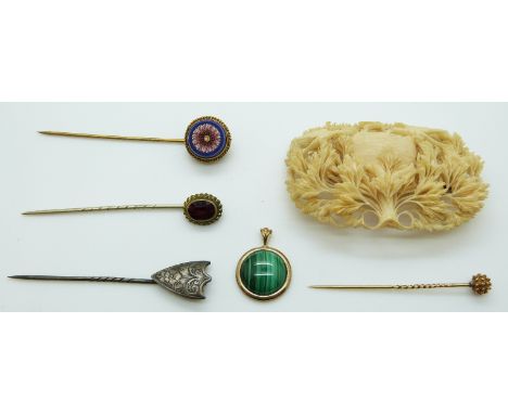 A 9ct gold pendant set with a malachite cabochon, stick pins including Victorian silver example and an ivory brooch depicting