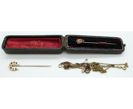 A yellow metal stick pin in the form of a horseshoe set with diamonds and rubies, a Victorian stick pin in the form of a shie