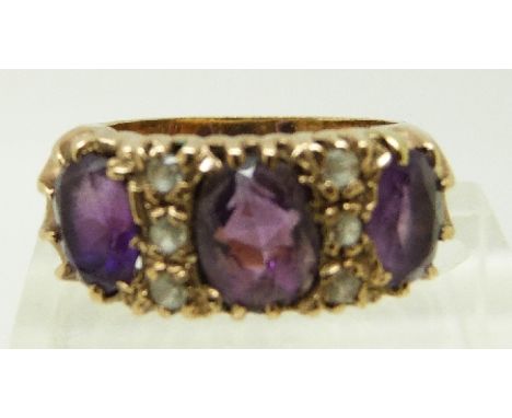 A 9ct gold ring set with three large amethysts and paste in original box, size J/K, 6.6g 