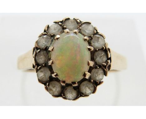 A 9ct gold ring set with an opal surrounded by paste, size K, 2.0g