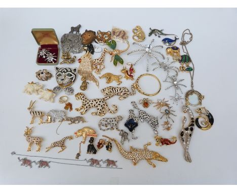 A large collection of brooches including ten leopard paste brooches some by Sardi, three giraffe brooches set with enamel and