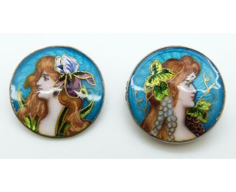 Two enamel buttons, one made into a brooch, each with enamel decoration of Art Nouveau ladies with flowers in their hair, ent