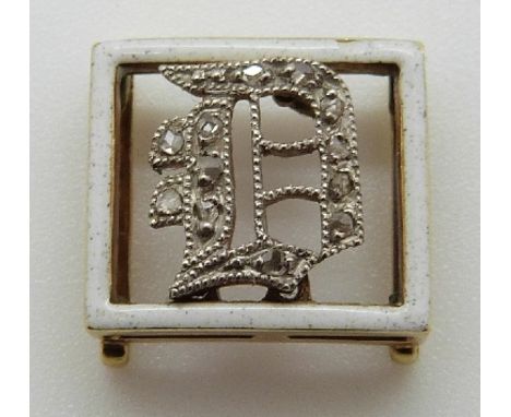 Victorian buckle set with white enamel border and an inset diamond D, in Asprey box 