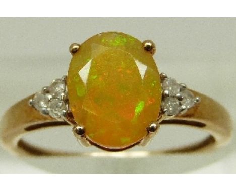 A 9ct gold ring set with yellow opal and diamonds, size N, 1.8g. 