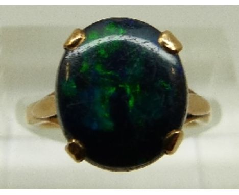 A 9ct gold ring set with a black opal doublet, size J, 2.9g 