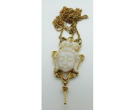 A 9ct gold necklace set with a carved opal Buddha in a scrolled border, in vintage Bristol box