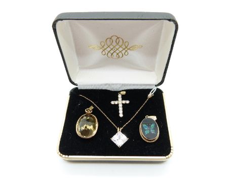 A 9ct gold pendant set with opal in a butterfly design, a Victorian pendant set with a citrine, a 14k gold pendant set with c