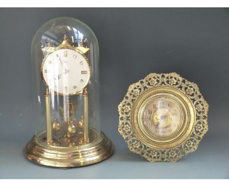 A c1910 circular brass easel clock, the Arabic chapter ring surrounding gilt classical scene depicting nude figure with lyre 
