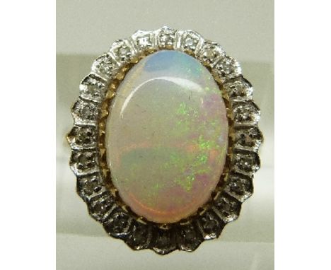 A 9ct gold ring set with a large opal cabochon surrounded by diamonds, size L, 4.1g. 