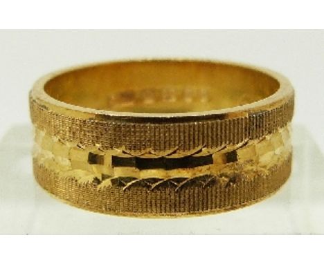 A 22ct gold ring/ wedding band with textured decoration, size L/M, 6.8g 