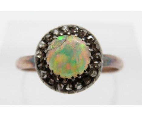 A Victorian ring set with a round cut opal cabochon surrounded by rose cut diamonds, size N, 1.7g 