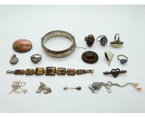 A collection of silver jewellery including a bangle, brooch, Chinese silver brooch set with tiger's eye, pearl and silver nec