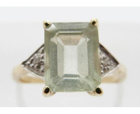 A 9ct gold ring with green topaz and two small diamonds either side, size K, 2.3g 