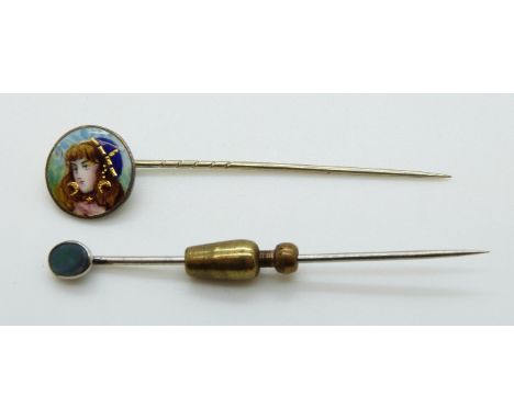 A white metal stick pin set with enamel depicting a young woman and an opal stick pin 