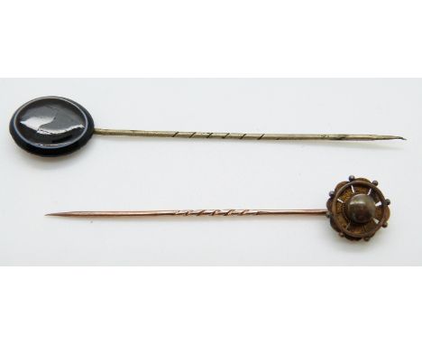 A Victorian stick pin set with a banded agate cabochon and a yellow metal Victorian stick pin