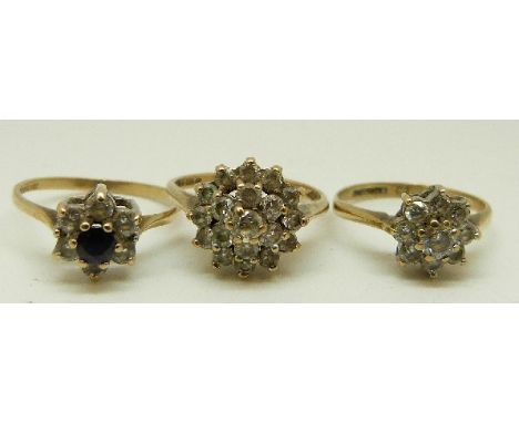 Two 9ct gold rings set with cubic zirconia and a 9ct gold ring set with a sapphire surrounded by cubic zirconia, size L/M, 1.