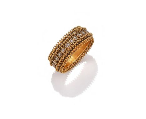 A DIAMOND BANGLE The hinged bangle with a central line of Kundan set vari shaped rose cut diamonds, between beadwork borders,