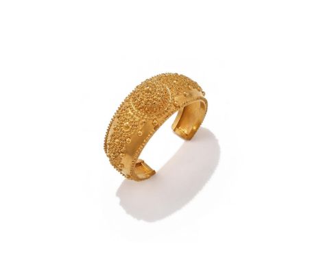 A CUFF BANGLE The tapered cuff with domed centre, decorated throughout with beadwork motifs, unmarked Size/dimensions: inner 