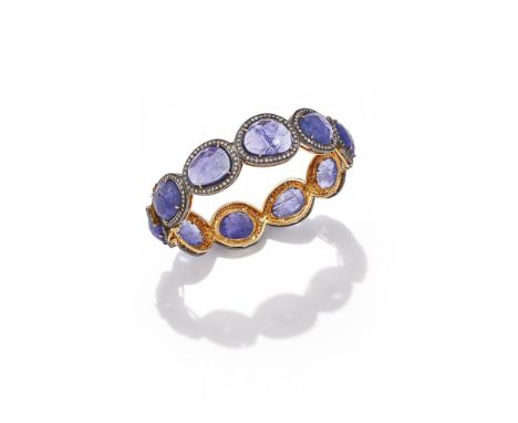 A TANZANITE AND DIAMOND BANGLE The hinged bangle composed of a row of rose cut tanzanites in single cut diamond surrounds, un