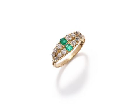 AN EARLY 20TH CENTURY EMERALD AND DIAMOND RING  The tapered panel with two rows of graduated old cut diamonds to a pair of ce