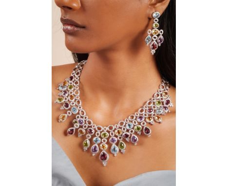 A GEM SET FRINGE NECKLACE AND EARRING SET The necklace of tapered fringe design, composed of oval and pear shaped openwork li