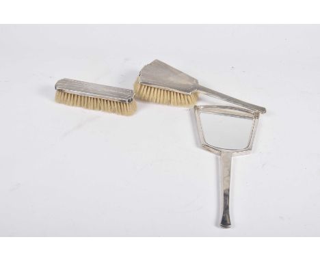 A matched silver Art Deco dressing table setWith geometric engine turned detail, comprising; hair brush, hand mirror and clot