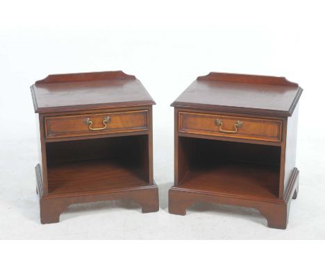 A pair of mahogany bedside chests each with a single frieze drawer, brass swan neck handle raised on bracket feet, 50cm wide.