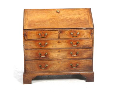 A Georgian mahogany bureauThe fall front enclosing a compartmentalised interior above two short and three long graduated draw