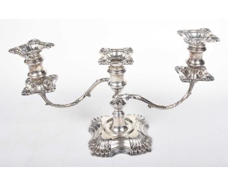 A George V silver two branch, three light candelabraThe central knopped stem with two scroll and leaf capped branches, each s