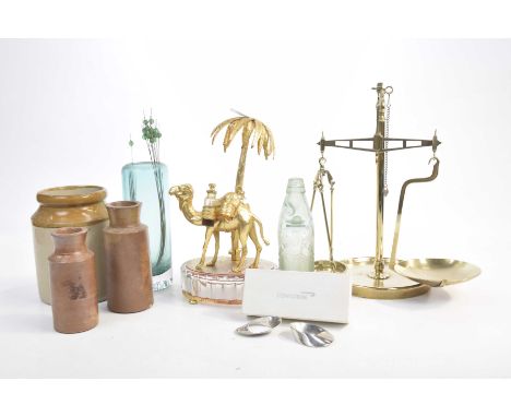 A gilt metal centrepiece in the form of a camel under a palm tree, late 20th CenturyCased pair of Concorde napkin rings, a pa
