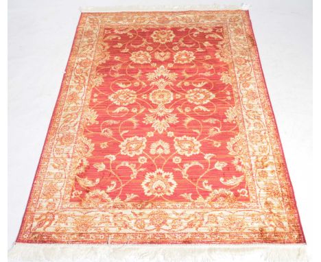 A red ground Ziegler carpetThe red, ochre and amber coloured carpet with central reserve filled with flowerheads, floral spra