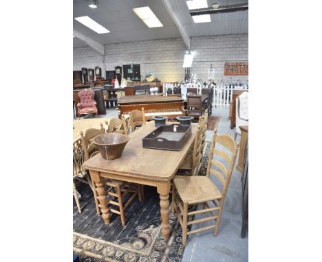 An elm and pine kitchen table and six ladder back chairsThe elm slab top table supported on pine turned legs along with a set