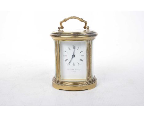 A brass cased Matthew Norman of London carriage clock, late 20th CenturyThe prize oval shaped carriage clock with inscription
