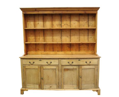 A Victorian pine Welsh dresserThe high back with a moulded cornice above two enclosed shelves, the base with a rectangular pl