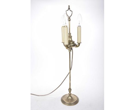 A brass rise and fall table lamp, early 20th CenturyThe 68cm high lamp with carrying handle, three lamp fittings with circula