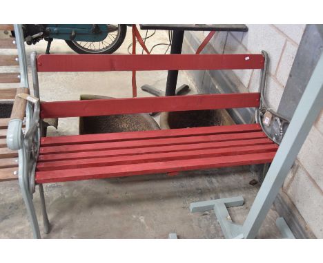 A painted hardwood and iron garden benchWith a rail back supported on  ironwork bracket supports, 121cm long.