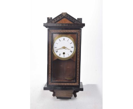 Wooden cased wall clock, late 19th/early 20th Century10cm white enamel dial with Roman numerals, glazed door, height 42cm.