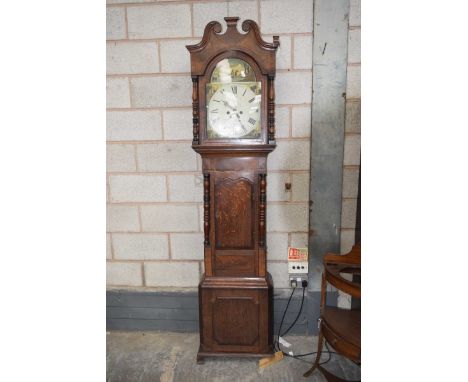 An early 19th Century oak and mahogany cross banded eight day long case clock by W Wain, BurslemHaving a broken twin swan nec