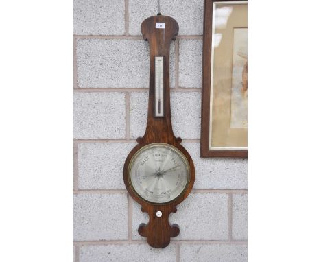 A late 19th Century Rosewood aneroid barometer, Mowrie, Liverpool The banjo shaped barometer with scrolling pediment enclosin