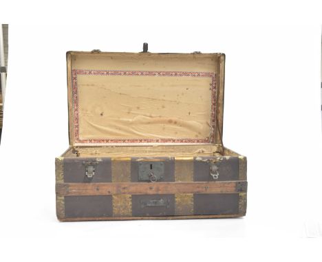 A wood and metal bound trunk, late 19th early 20th CenturyBanded trunk, lid to reveal paper covered interior with metal carry