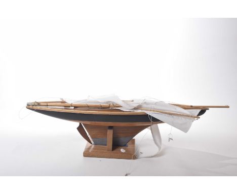 A vintage pond yacht, 20th Century Complete with stand, with metal keel and instruction leaflet. 