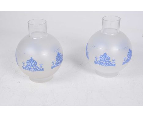 A group of five contemporary frosted glass oil lamp shades Each of rounded form, with blue etched foliate designs.